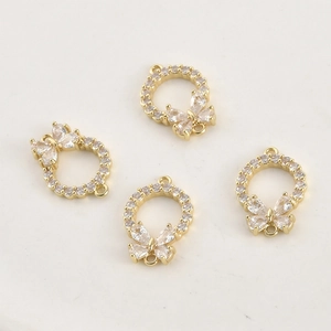 Macro detail of 14k gold plated butterfly wreath charms with sparkling zircon for DIY jewelry