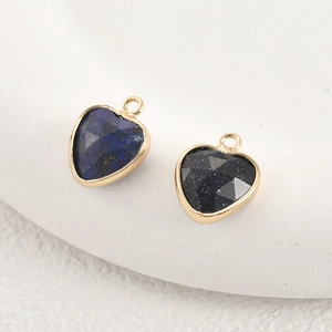 Macro view of gold-plated natural crystal heart charms for DIY jewelry making