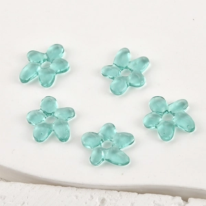 Detailed view of five translucent blue handmade glass flower beads for DIY jewelry making
