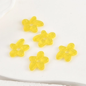 Detail of five handmade yellow glass flower beads with center holes for DIY jewelry