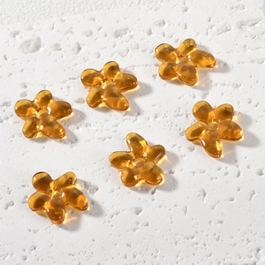 Close-up of amber glass five-petal flower beads for DIY jewelry making accessories