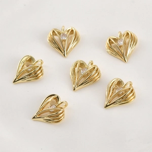 Detailed view of 14k gold plated heart pendants with striped hollow design and zircon
