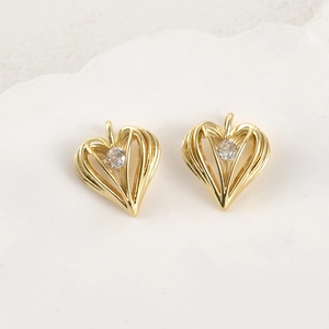 Close-up of 14k gold plated heart pendants with sparkling cubic zirconia stone center