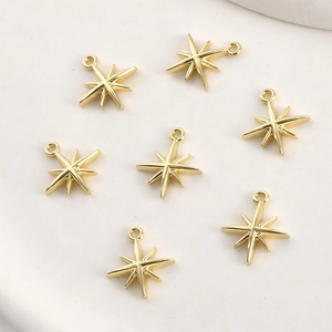 Macro detail of 14k gold plated star pendants with shiny zircon for DIY jewelry making