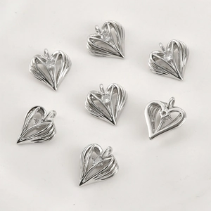 Detailed view of hollow heart pendants with cubic zirconia for jewelry making