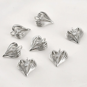 Macro view of several silver hollow heart pendants with sparkling cubic zirconia centers