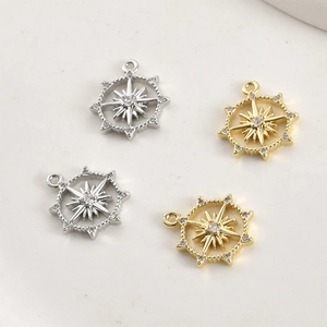 Close-up of gold and silver star pendants with sparkling cubic zirconia settings