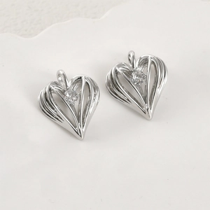 Detailed view of 14k gold-plated heart pendant with zircon inlay and hollow design