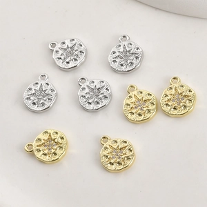 Detailed view of 14k gold plated starburst pendants with sparkling zircon inlays