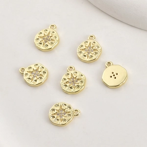 Macro shot of 14k gold-plated starburst pendants with sparkling zircons for jewelry making