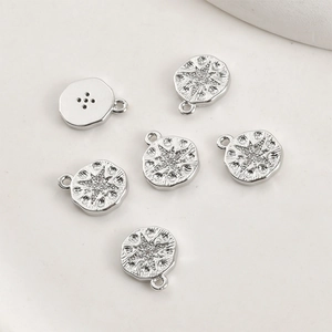 Detail of silver eight-point star pendants with hammered texture and cubic zirconia stone