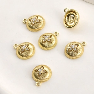 Macro view of 14k gold-plated star charms with zircon inlay and vertical texture