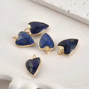 Vue macro de 5 pendentifs cœur en lapis-lazuli bleu avec bordure en métal doré