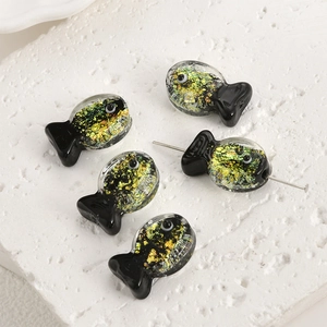 Macro shot of glass fish beads with gold foil inclusions for DIY jewelry making