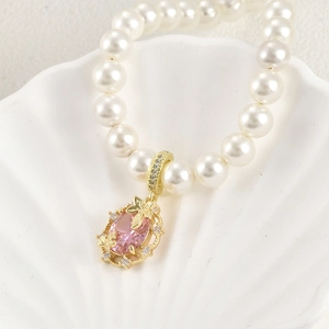 14k gold plated pearl bracelet with pink oval gemstone and sparkling butterfly pendant