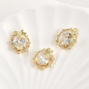 Detailed view of 14k gold-plated leaf pendants with oval zircons for DIY jewelry making