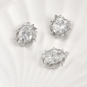 Macro detail of 14k gold plated oval leaf pendants with sparkling cubic zirconia for DIY