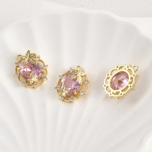 Macro view of 14k gold plated pink zircon pendant with hollow leaf and butterfly details