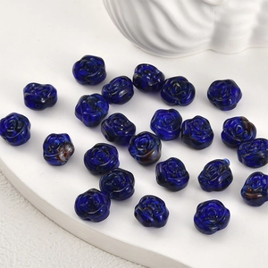 Macro view of blue glass rose beads for handmade jewelry making and DIY crafts