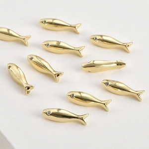 Detailed view of 14k gold-plated fish beads with sparkling zircon eyes for DIY jewelry