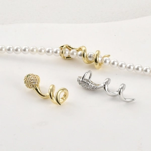 14k gold plated snake pendant with shimmering zircons shown on a pearl necklace