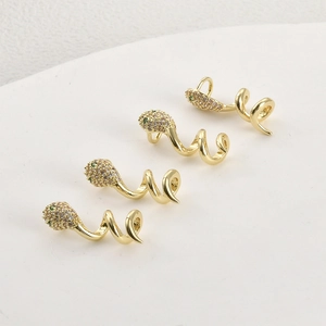 Close-up of 14k gold plated snake earrings with green zircon eyes and micro-set diamonds