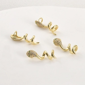 Macro shot of 14k gold-plated snake charms with cubic zirconia stones for DIY jewelry