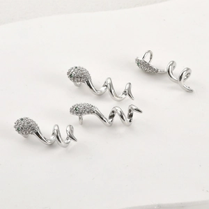 14k gold plated snake earrings with white cubic zirconia and green eyes on white base