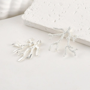 Close-up of coral-shaped 14k silver plated pendant charms for DIY jewelry making