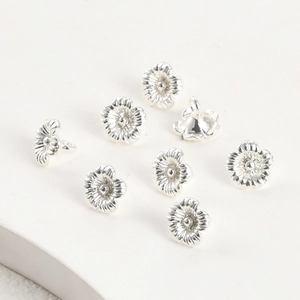 Dettaglio di 8 ciondoli a fiore d'argento con placcatura 14k per la creazione di gioielli DIY
