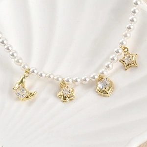 14k gold filled pearl necklace with star, moon, heart, and flower zircon charms