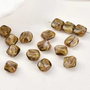 Macro shot of marble textured brown and cream square glass beads for DIY jewelry making