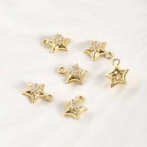 Macro detail of 14k gold-filled star pendants with sparkling cubic zirconia for DIY jewelry