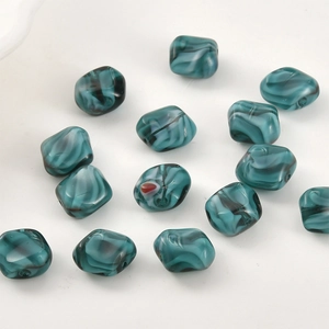 Macro detail of dark green marble-textured square glass beads for DIY jewelry making