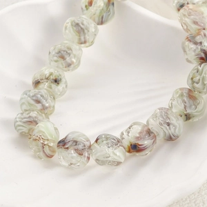 Handmade purple spiral pattern glass beads for DIY jewelry making in white shell tray