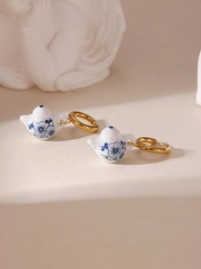Detail of creative blue and white porcelain mini teapot earrings with 18K gold hooks