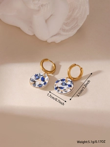 Detailed view of porcelain earrings with 18K gold plated hoops and size dimensions