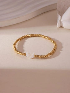 Detail of 18K gold-plated beaded bracelet with a white crescent moon shell charm