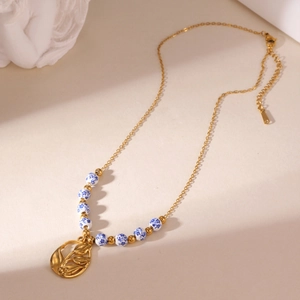 18K gold plated necklace with blue and white porcelain beads and hollow flower pendant