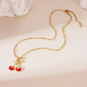 Detailed shot of 18K gold plated paperclip chain necklace with red cherry pendant
