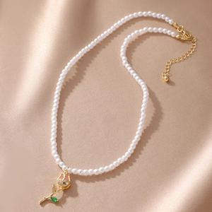 Detail of rose pendant necklace with pearls, gold lobster clasp and extension chain