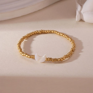 18K gold plated beaded bracelet featuring a white mother of pearl crescent moon pendant