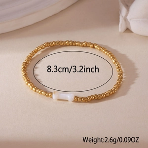 18K gold-plated beaded bracelet with a white heart bone charm and golden spheres