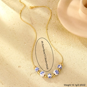 18K gold plated snake chain necklace with blue and white porcelain beads and gold charms