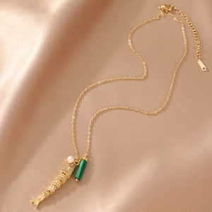 18K gold fish necklace with malachite bead and pearl on champagne satin background