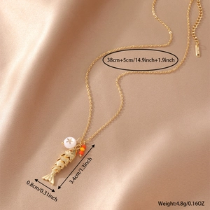18K gold plated fish necklace with natural stone and star bead on satin background