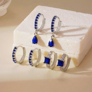 Three pairs of elegant copper earrings set with blue square zircon stones in silver tone