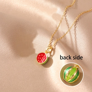 Detail view showing back of gold watermelon pendant with green texture and chain