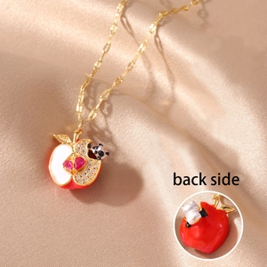 Macro detail of apple panda pendant with red heart gems and golden back side view