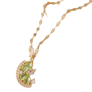 Golden crescent moon necklace with green teardrop gemstones and white crystals